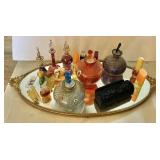 Oval vanity mirror with glass perfume bottles