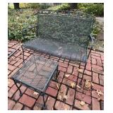 Wrought iron patio settee and side table