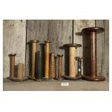 Antique wooden spools on mantel
