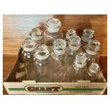 11 glass apothecary jars with ground stoppers