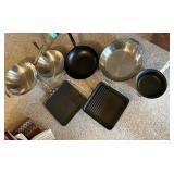 Crate with All-Clad pans, white Le Creuset pot