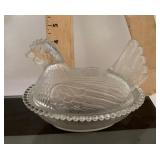 Clear glass hen on a nest