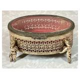 Oval metal jewelry casket with cherub feet