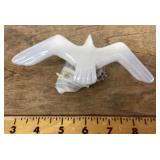 Carved stone seagull on seashell