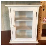 Small white cabinet with glass door