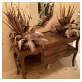 Display table at entrance with feathers