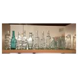 Glass bottles on kitchen shelf
