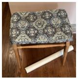 Wooden stool with upholstered seat