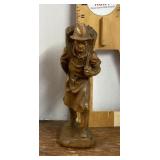 Carved wood statue of man carrying basket