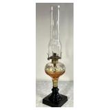 Antique oil lamp with black glass base