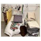 Large group of bed and table linens & hangers