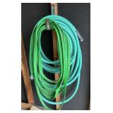 2 garden hoses on garage wall