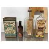Vintage extract bottles and cocoa tin