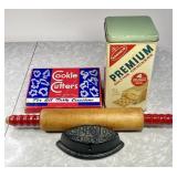 Cracker tin, sad iron, cookie cutters, rolling pin
