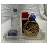 Avon perfume bottles on Pyrex fridge dish lid