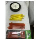Tent pegs and lawn mower wheel