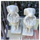 2 concrete dogs with baskets