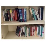 2 shelves of books in cabinet