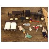 Collection of dollhouse furniture and dolls