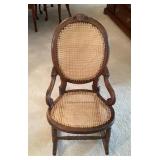 Victorian-style rocker with caned seat and back