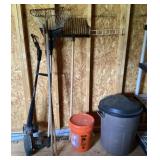 Long handled tools and trashcan of birdseed