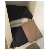 Pillows, blankets, and curtain rods in closet