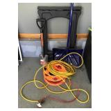 Folding sawhorse, shovels, and extension cords