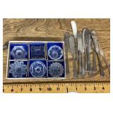Glass salt cellars and silverplate flatware