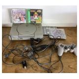PlayStation console with controller and games