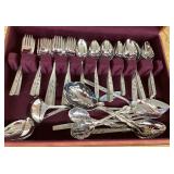 Assorted stainless flatware in case