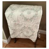 Cross-stitched quilt and quilt rack