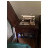 Singer sewing machine in cabinet