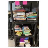 Shelf full of books --mainly kids