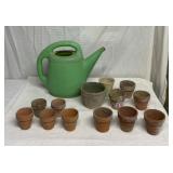 Clay flower pots and plastic watering can