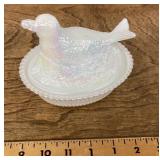 White iridescent glass bird on nest