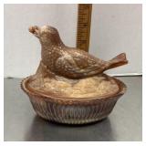 Brown slag glass bird on a nest