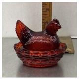 Small ruby glass hen on a nest