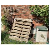 Pallets, hose reel, trellis on side of house