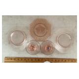 Pink Depression glass plates and candleholders