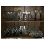 2 shelves full of clear glass