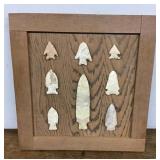 Arrow points mounted on oak board