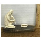Carved snake charmer figure
