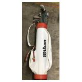 Wilson golf bag with assorted clubs