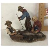 Cowboys branding a calf figure