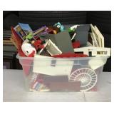 Tote full of toys and plastic barns
