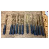 Collection of gold tone forks and knives