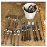 Bucket of silverplate flatware