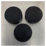 3 hockey pucks