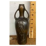 Ceramic vase with figure in relief