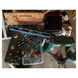 Items on floor in corner of garage with WorkMate